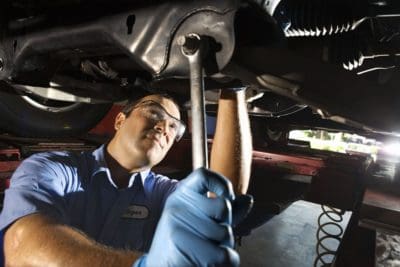 Mechanic working under a car