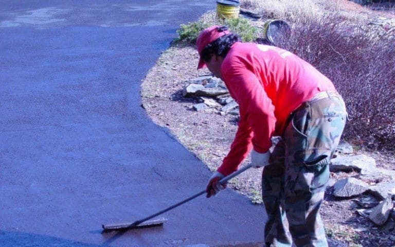 SAB-Landscape-Tree-Service-Walkway-1 SAB employee spreading tar on a driveway